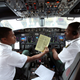 Pilots sit in the cockpit as they prepare the Ethiopian Airlines ET314 flight to Eritrea's capital Asmara at the Bole International Airport in Addis Ababa, Ethiopia July 18, 2018.